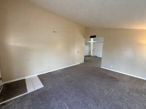 Empty room featuring light carpet and baseboards