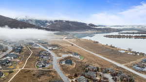 Aerial view of residential area featuring a water and mountain view