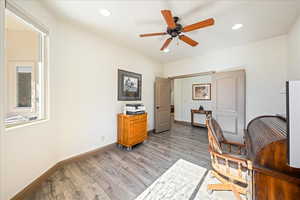 Sitting room with light wood-style flooring, ceiling fan, a desk, and recessed lighting