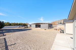 View of yard featuring an outbuilding and an exterior structure