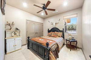 Bedroom featuring a closet, a ceiling fan, recessed lighting, and light colored carpet