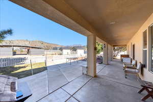 Fenced backyard featuring a patio and a mountain view
