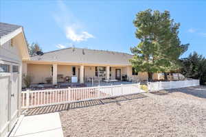Rear view of property featuring a fenced backyard, a patio area, and stucco siding