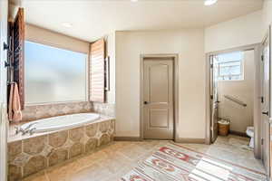 Bathroom featuring a bath, recessed lighting, and light tile patterned floors