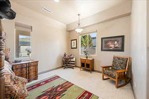 Sitting room featuring baseboards and carpet