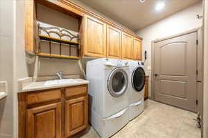 Laundry room with cabinet space and separate washer and dryer