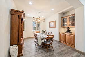 Dining area with light wood-style flooring and recessed lighting