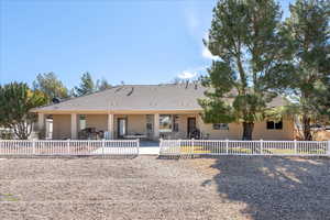 View of front of house with stucco siding, a patio, and a tile roof
