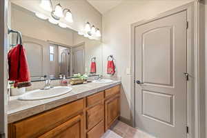 Bathroom featuring double vanity and light tile patterned floors