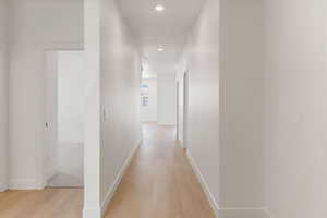 Hallway featuring light wood-style flooring and recessed lighting