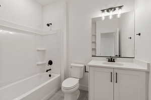 Bathroom with vanity, shower / tub combination, and light tile patterned floors