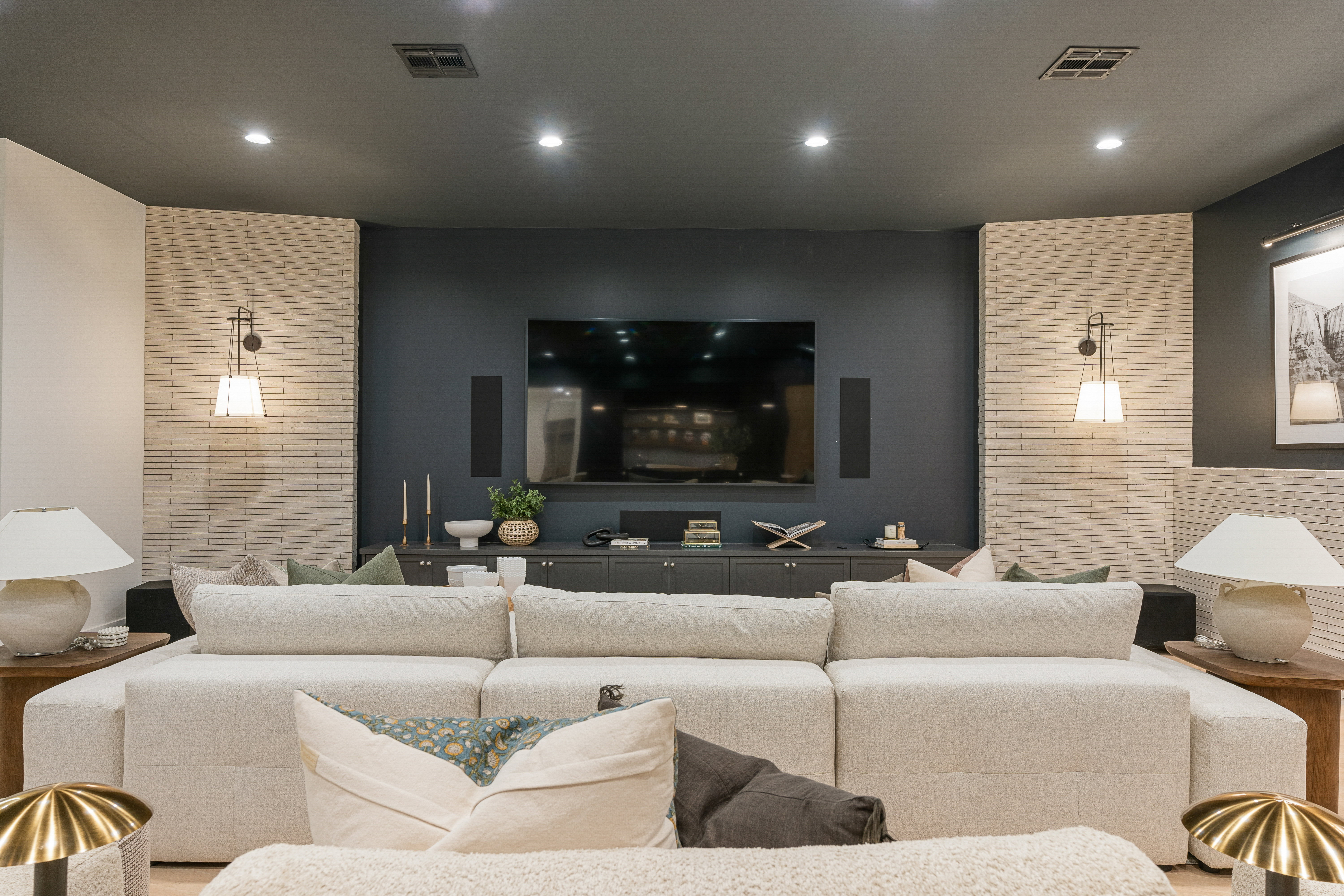 Home theater with recessed lighting and an accent wall