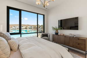 Bedroom with hanging lights and wood finished floors
