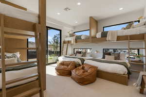 Bedroom with light colored carpet, recessed lighting, and access to exterior