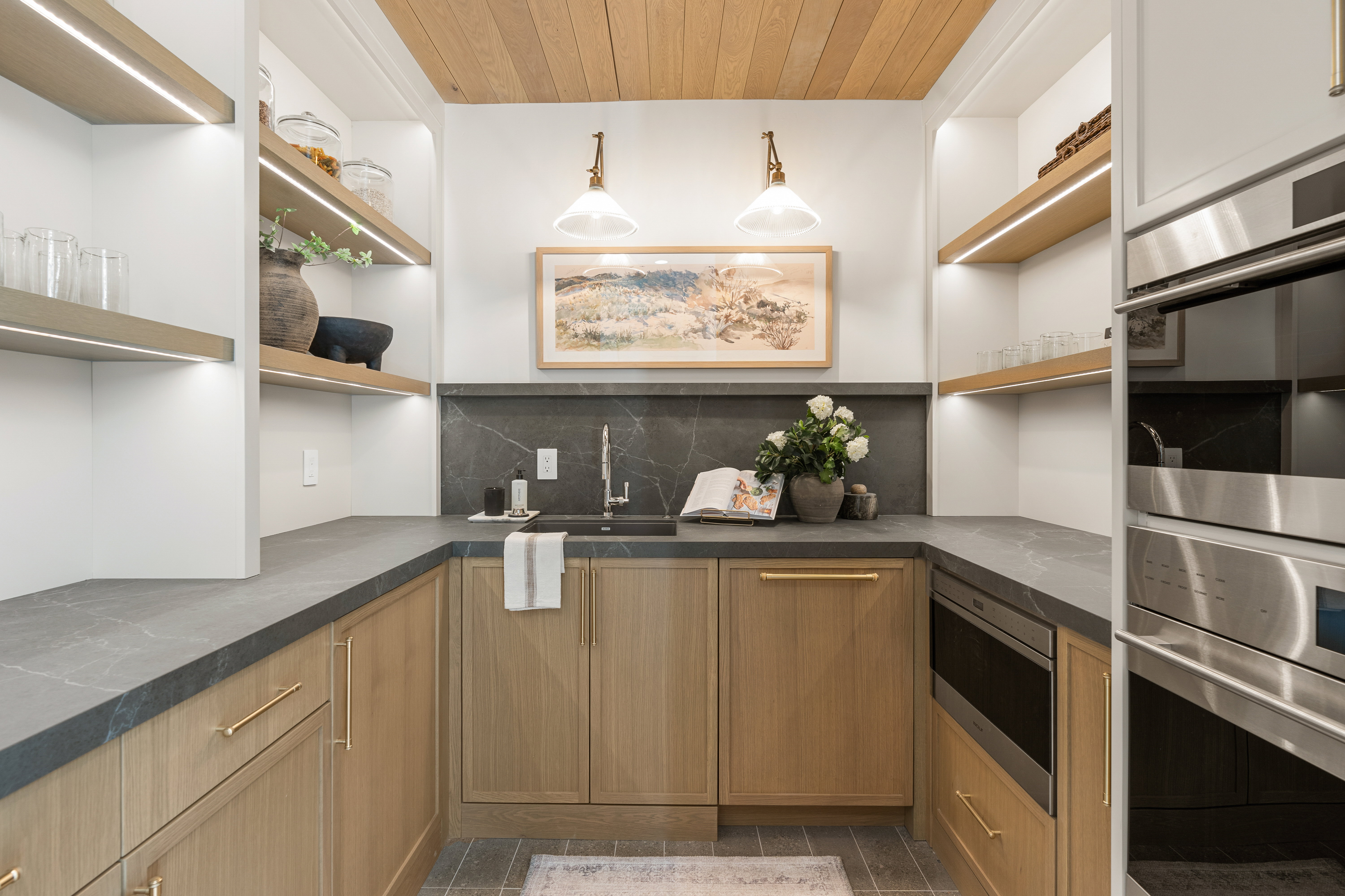 Kitchen featuring wooden ceiling, stainless steel appliances, open shelves, and decorative backsplash