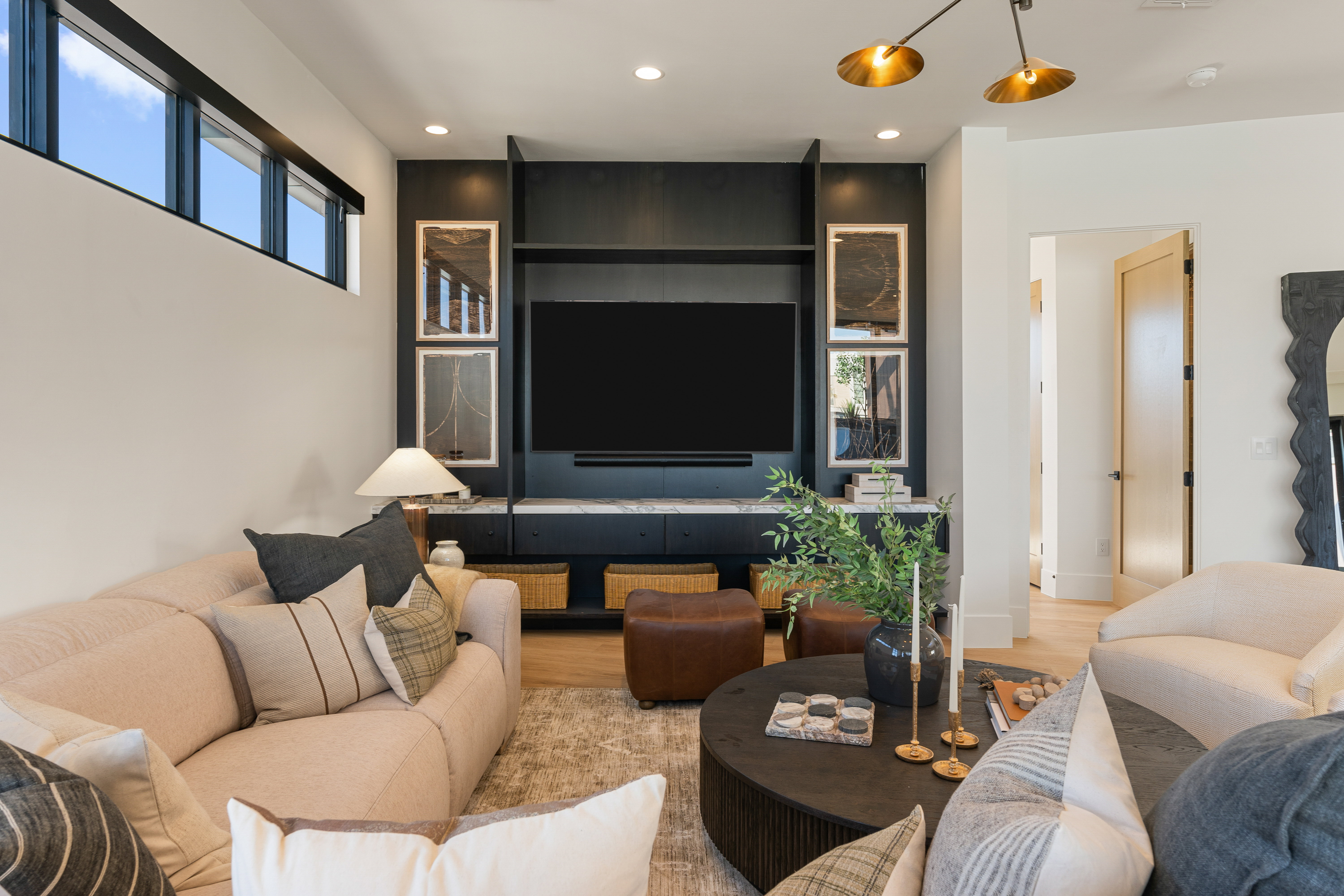 Living room with light wood-type flooring and recessed lighting