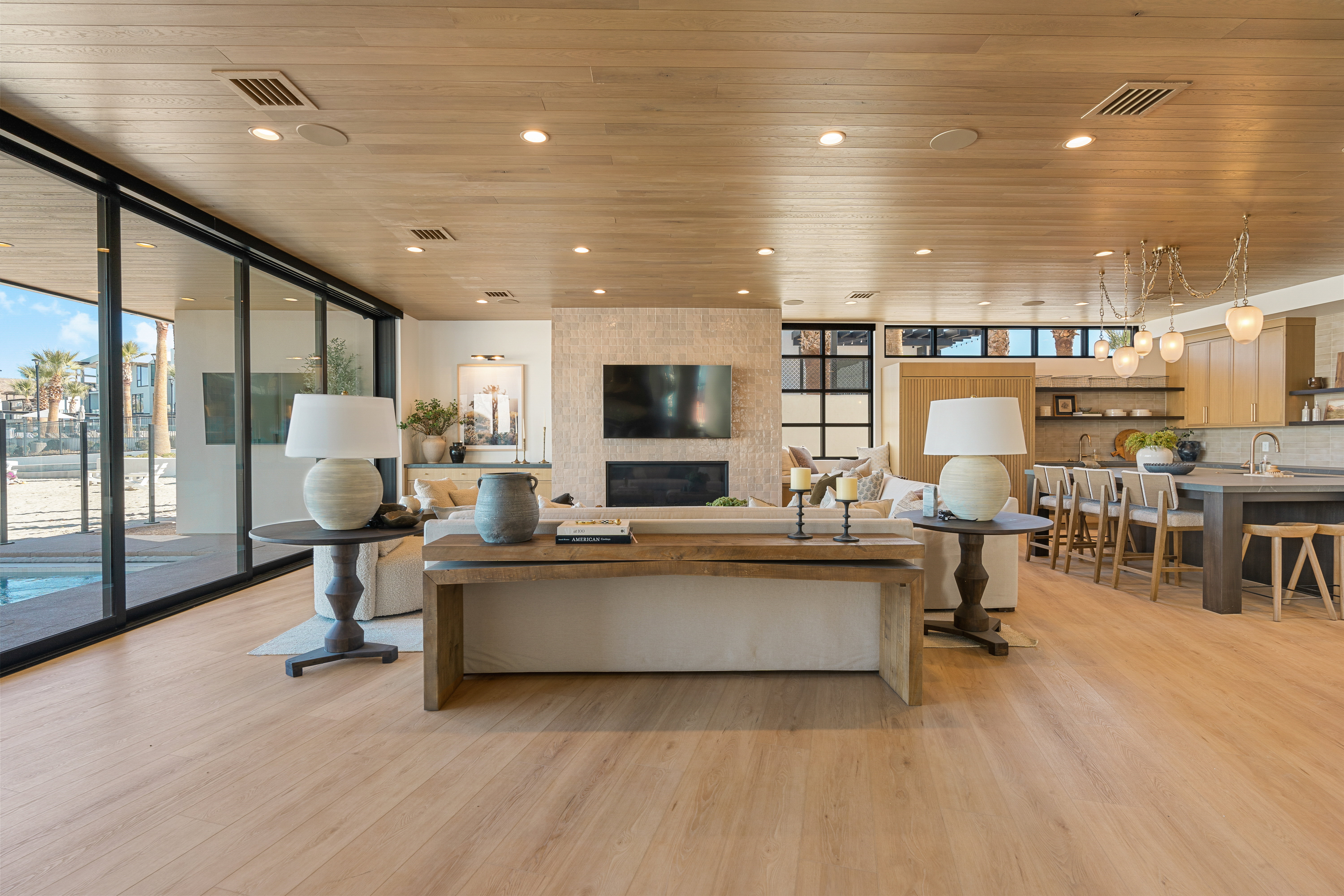 Living area featuring floor to ceiling windows, light wood-style floors, wooden ceiling, and recessed lighting