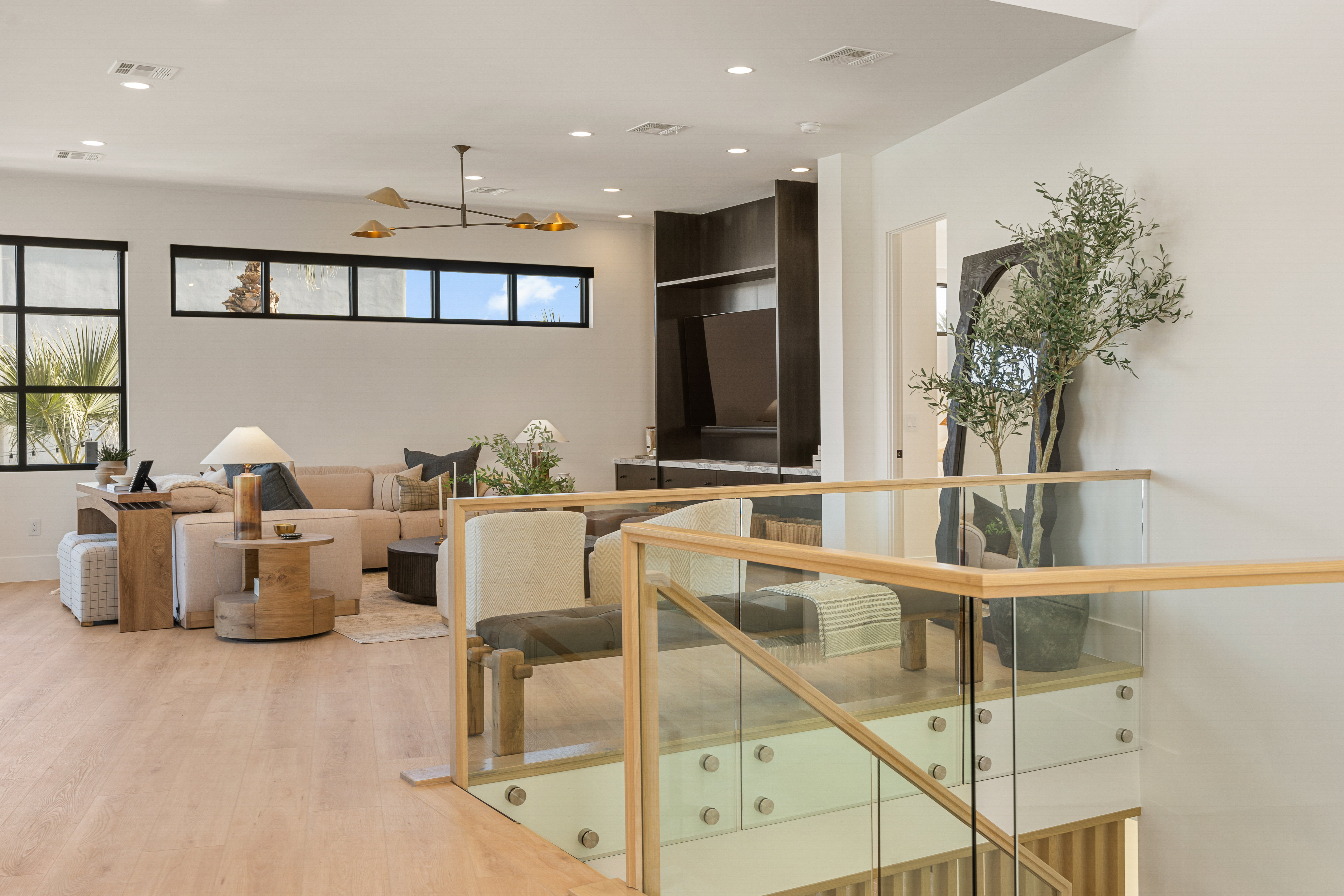 Living area with recessed lighting, light wood-style flooring, and a ceiling fan