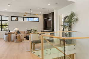 Living area with recessed lighting, light wood-style flooring, and a ceiling fan