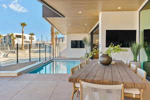 View of pool with patio surround and outdoor dining space