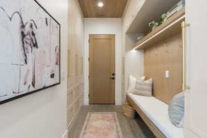 Mudroom featuring dark tile patterned floors, wood ceiling, and recessed lighting