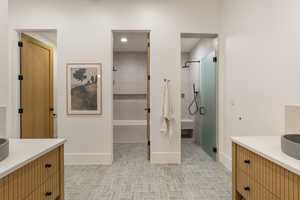 Full bathroom with vanity and a shower stall