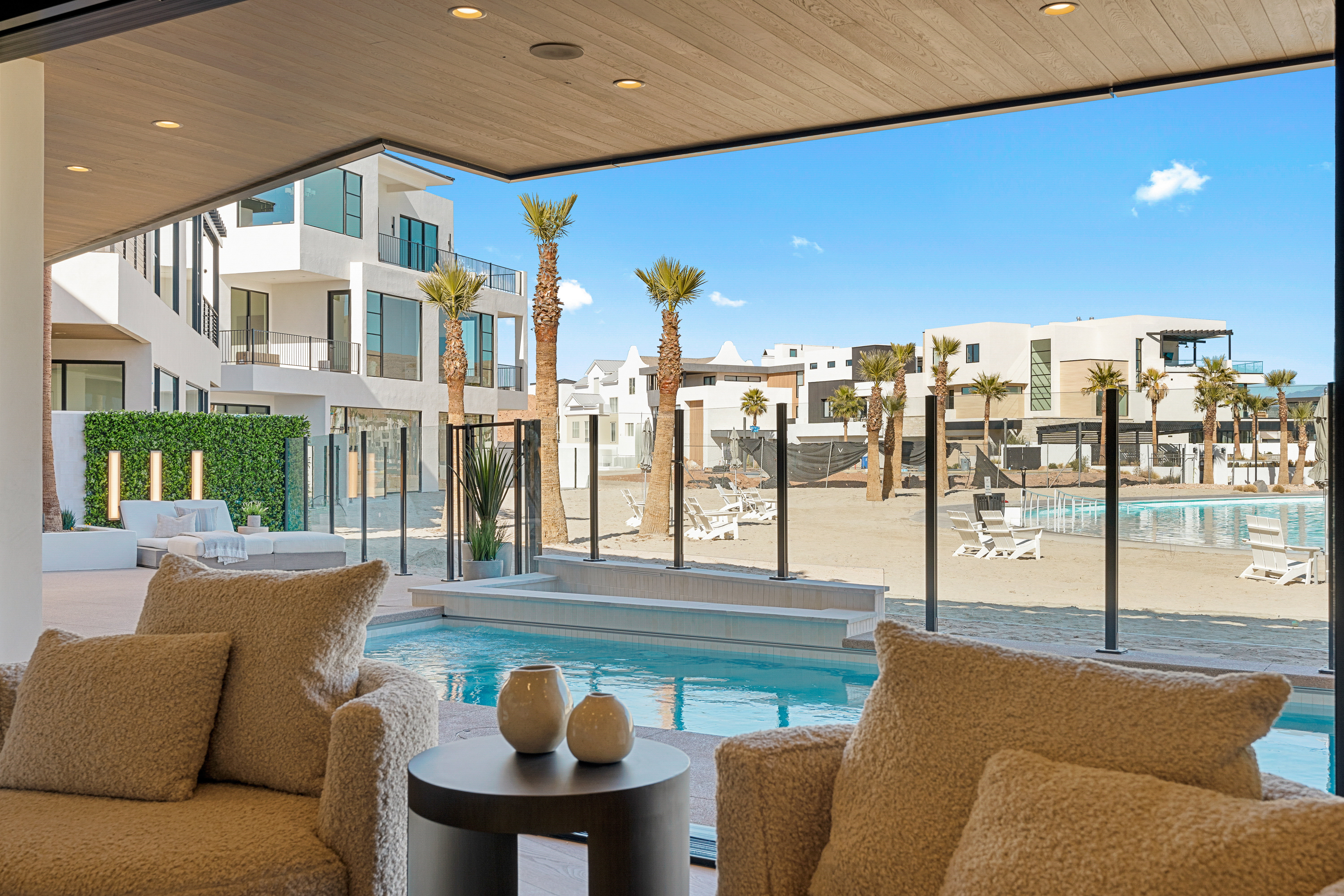 Community pool with a patio area and a residential view