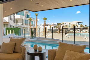 Community pool with a patio area and a residential view