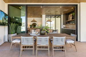 Dining room featuring floor to ceiling windows and wooden ceiling