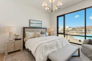 Bedroom with a chandelier, a mountain view, and light wood-style floors