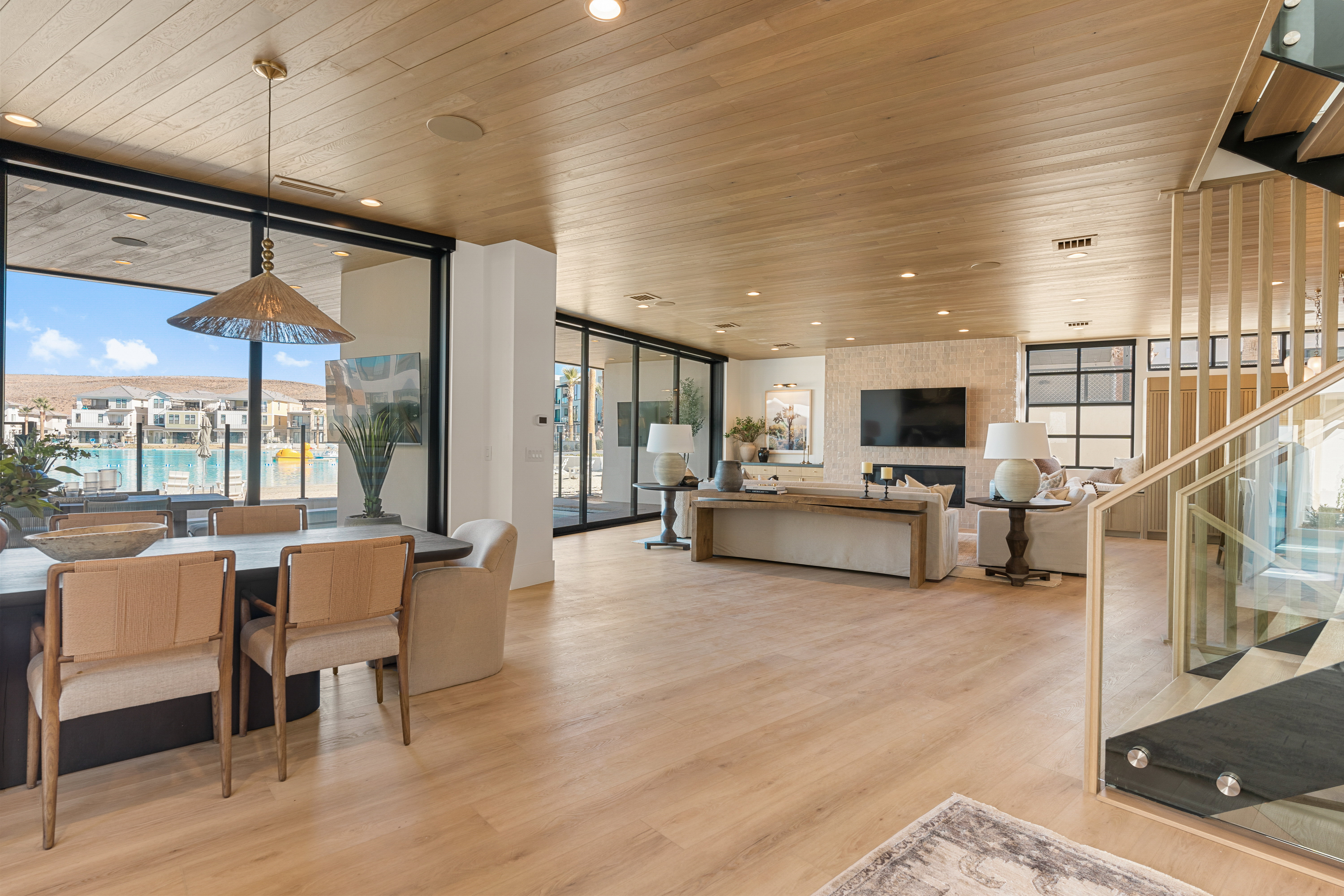 Living room with expansive windows, light wood-style floors, recessed lighting, and wood ceiling
