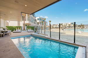 Community pool featuring a patio, a residential view, and outdoor dining space