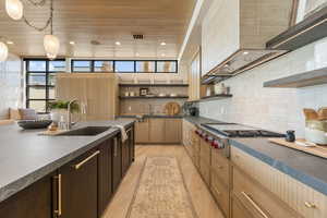 Kitchen with open shelves, dark countertops, wooden ceiling, stainless steel gas cooktop, and backsplash