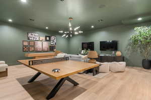 Game room featuring suspended lighting