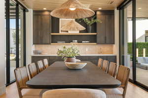 Dining room with expansive windows and light wood-style flooring
