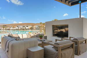 View of patio / terrace featuring an outdoor living space, a community pool, and a residential view