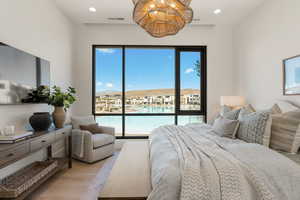 Bedroom featuring light wood finished floors, recessed lighting, a mountain view, and access to exterior