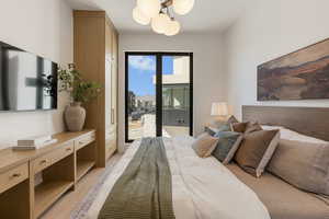 Bedroom featuring light wood-style flooring and access to exterior