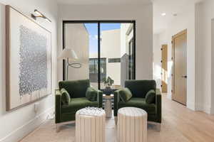 Sitting room featuring baseboards and wood finished floors