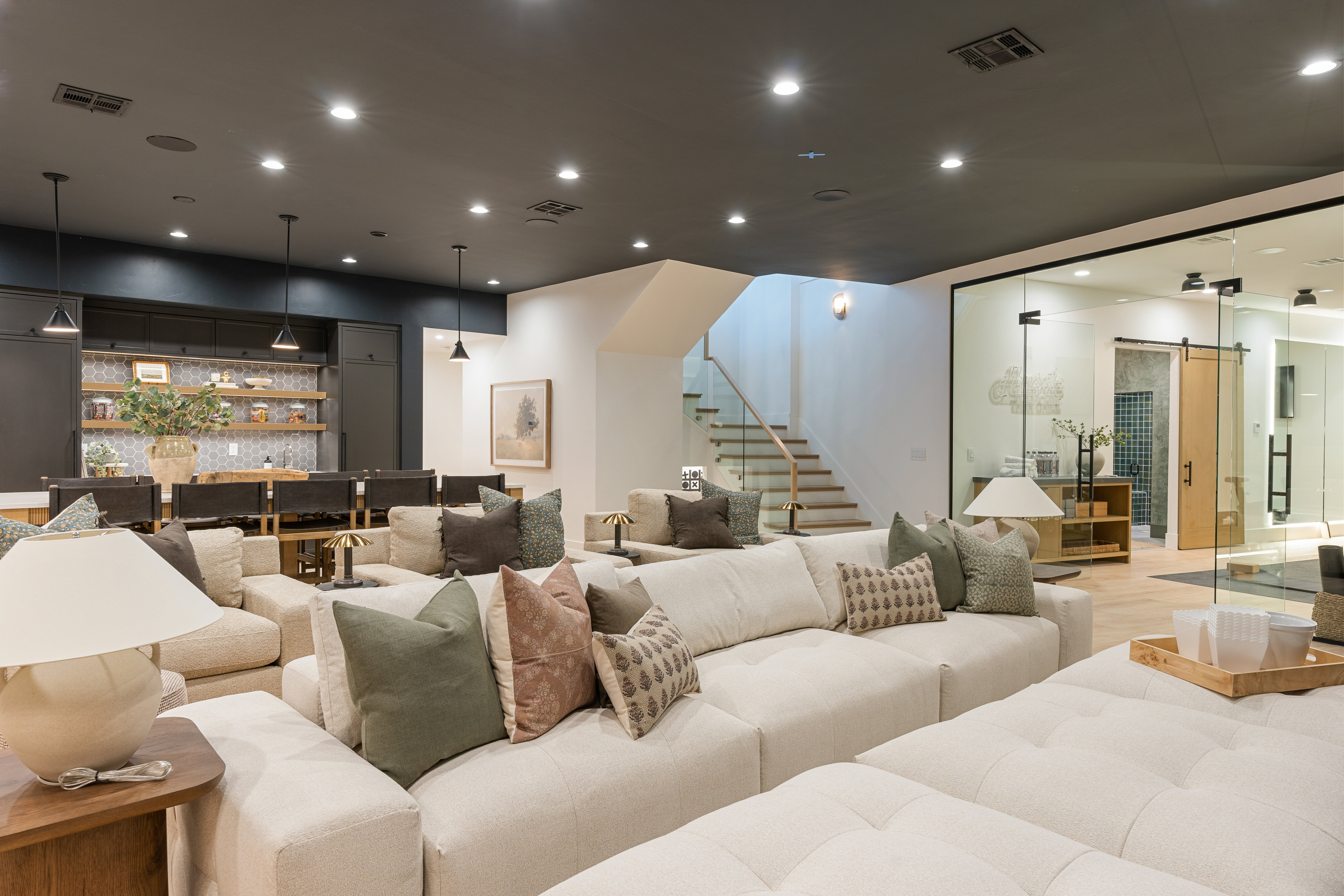 Cinema room featuring bar with sink, a barn door, and recessed lighting
