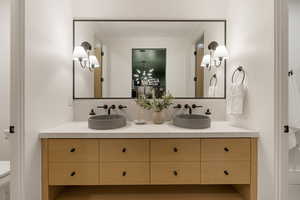Bathroom with tasteful backsplash and double vanity
