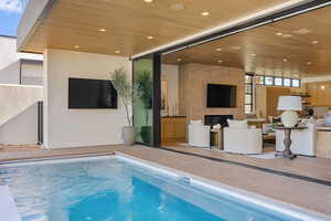 Indoor pool featuring a patio area