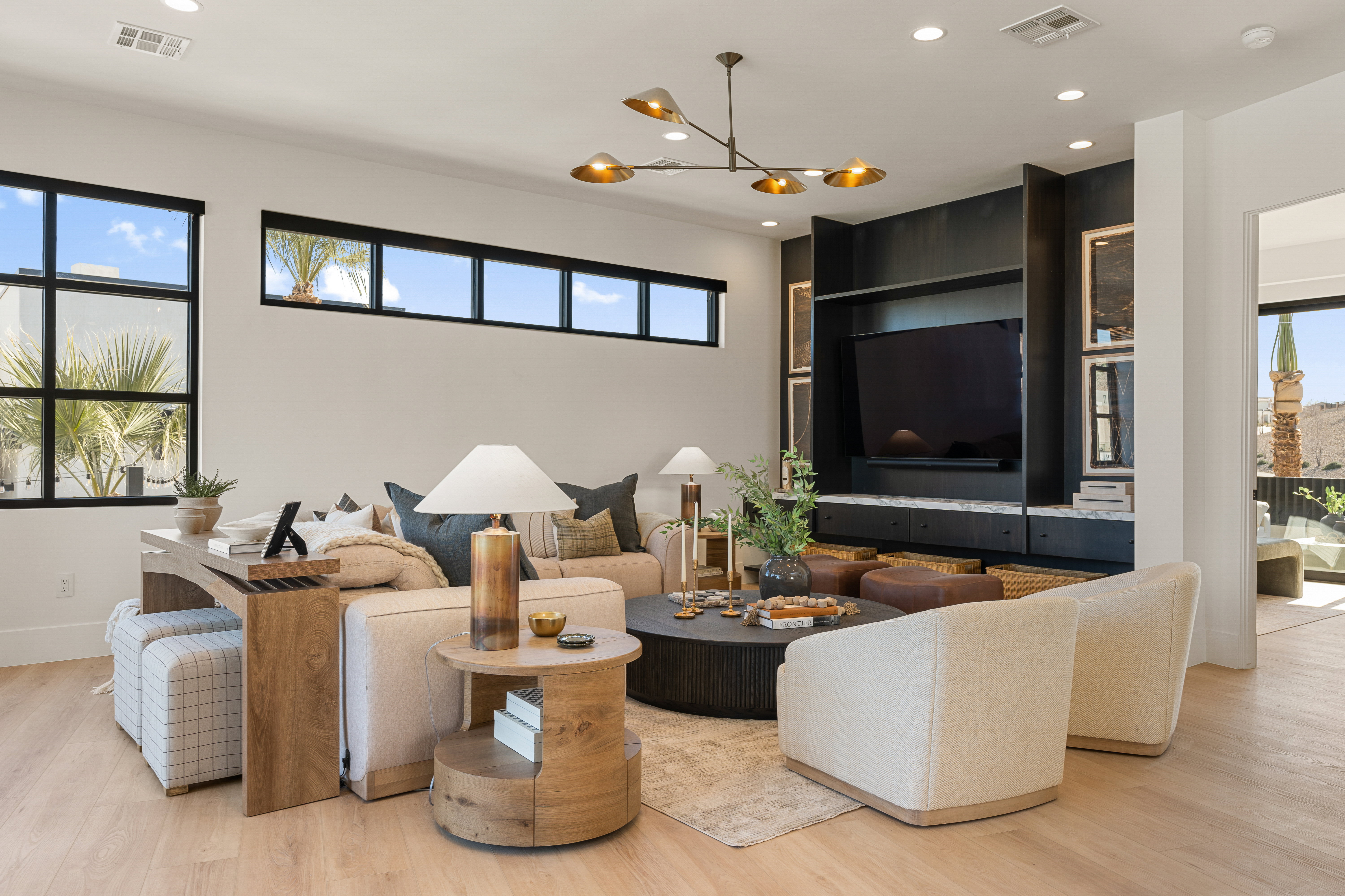 Living room featuring light wood-style floors, healthy amount of natural light, and hanging lights
