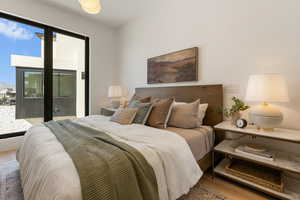 Bedroom featuring access to outside and light wood-type flooring