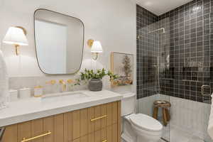 Bathroom featuring a shower stall and vanity