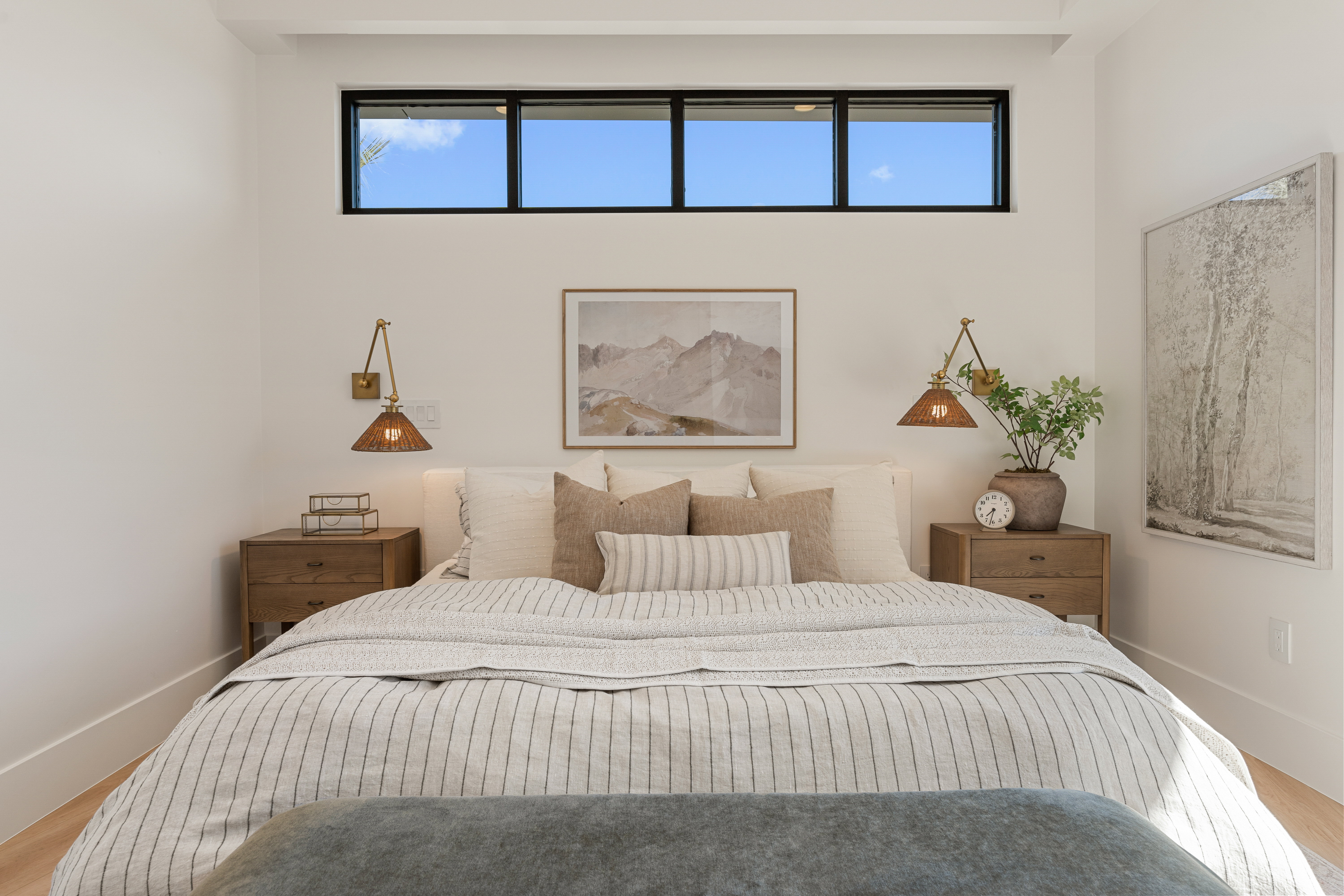 Bedroom with wood finished floors and multiple windows