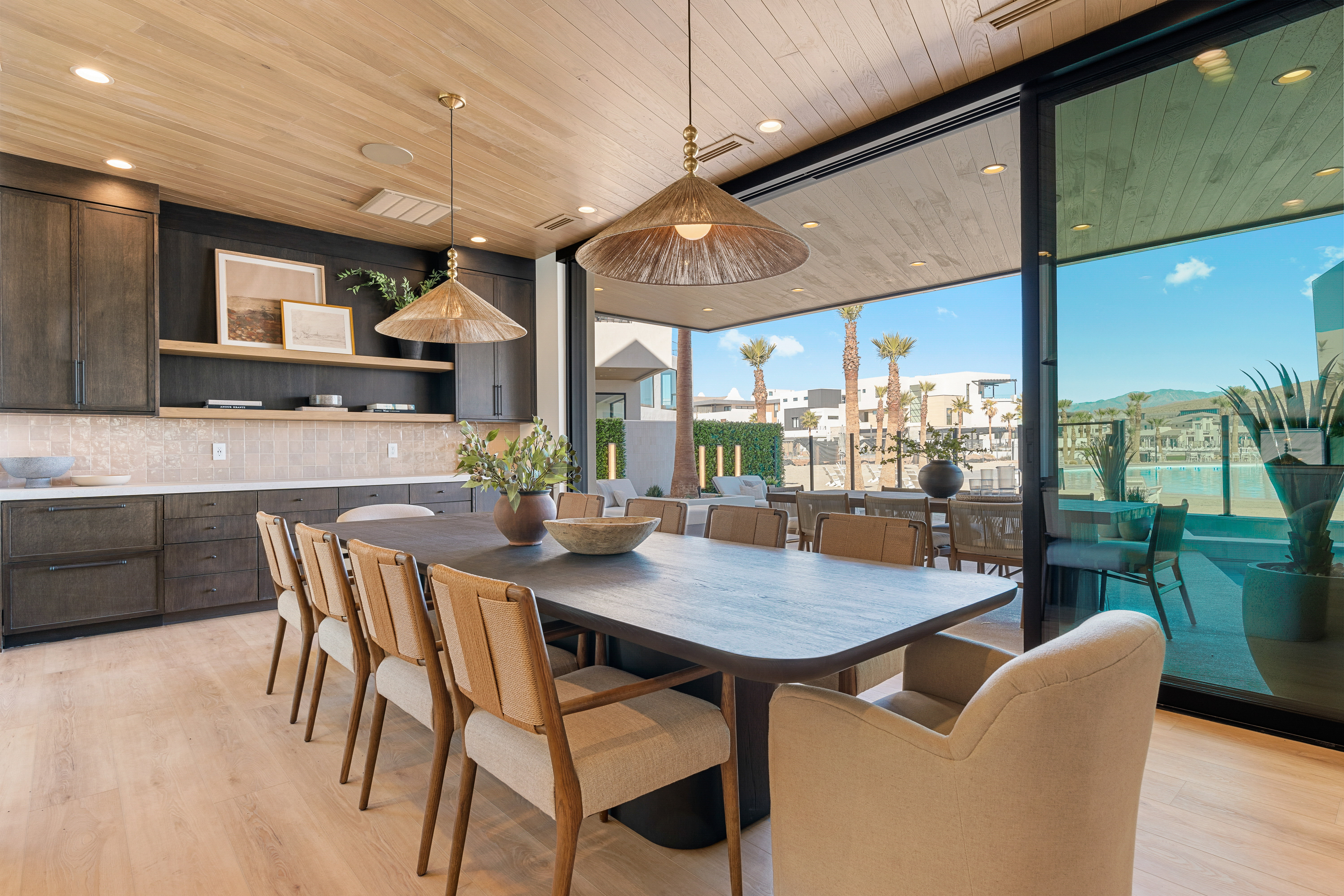 Dining area with expansive windows, light wood-type flooring, wooden ceiling, and recessed lighting