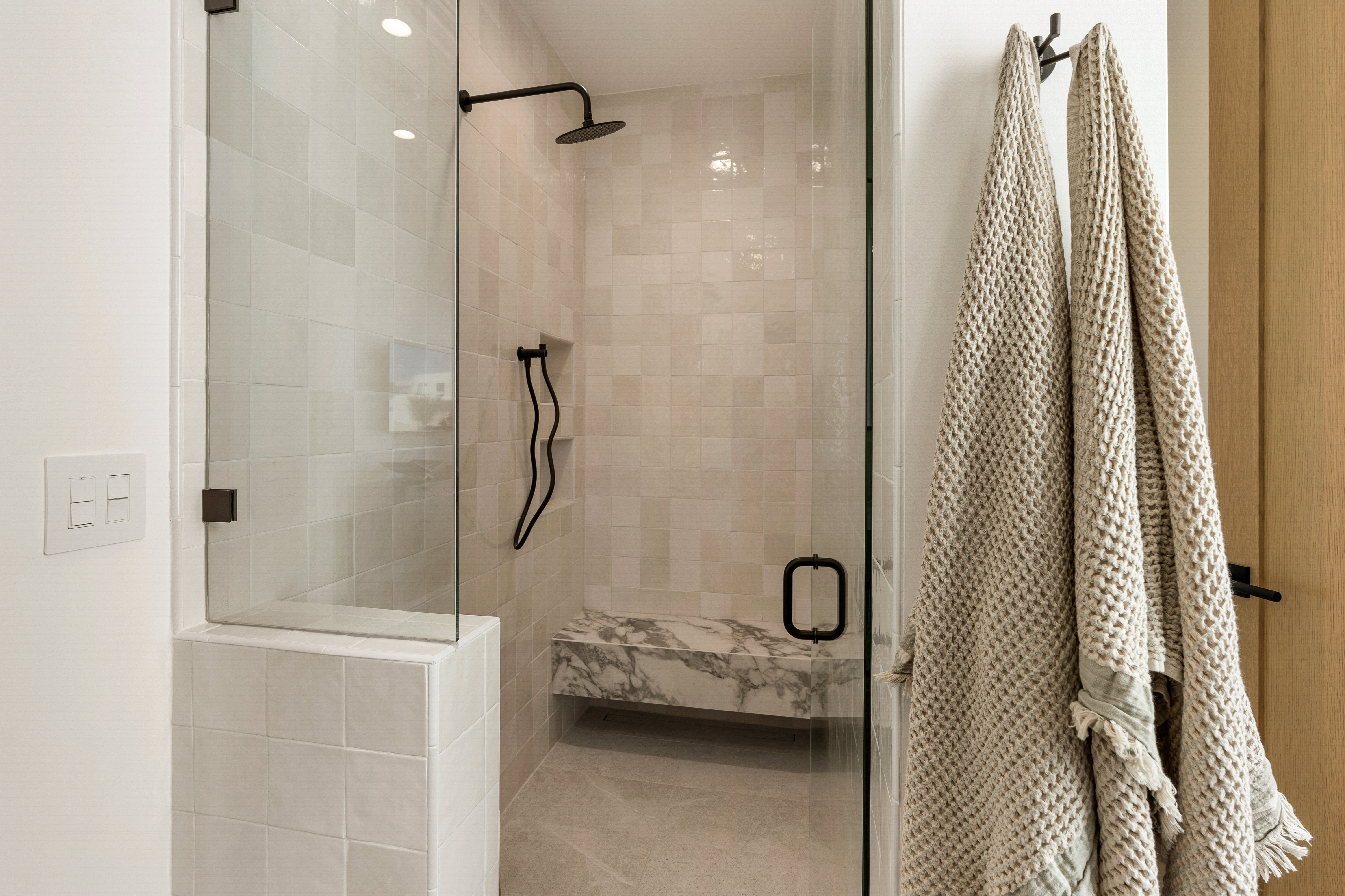 Bathroom with a shower stall and tile patterned floors