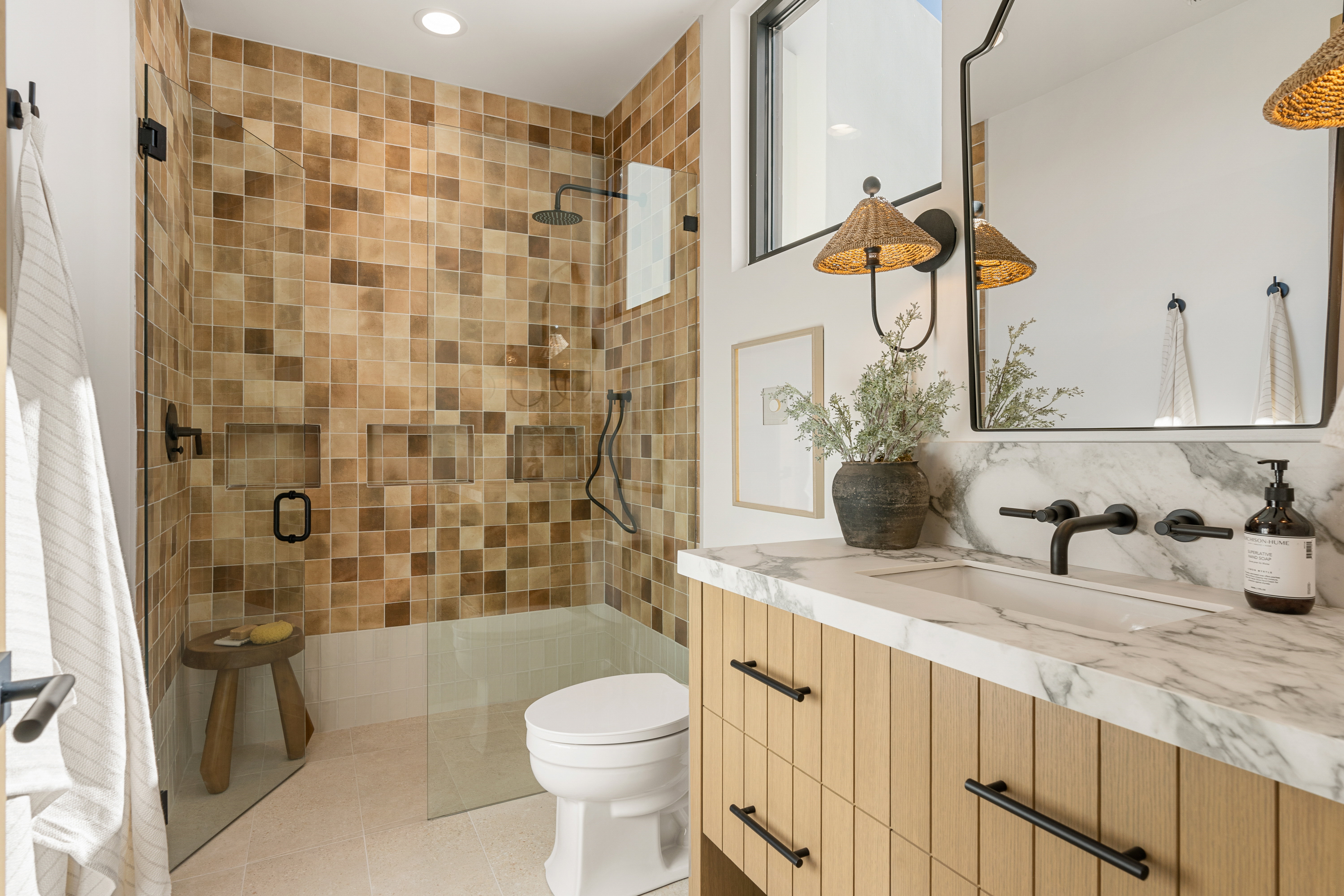Full bathroom featuring a stall shower, vanity, light tile patterned floors, and tasteful backsplash