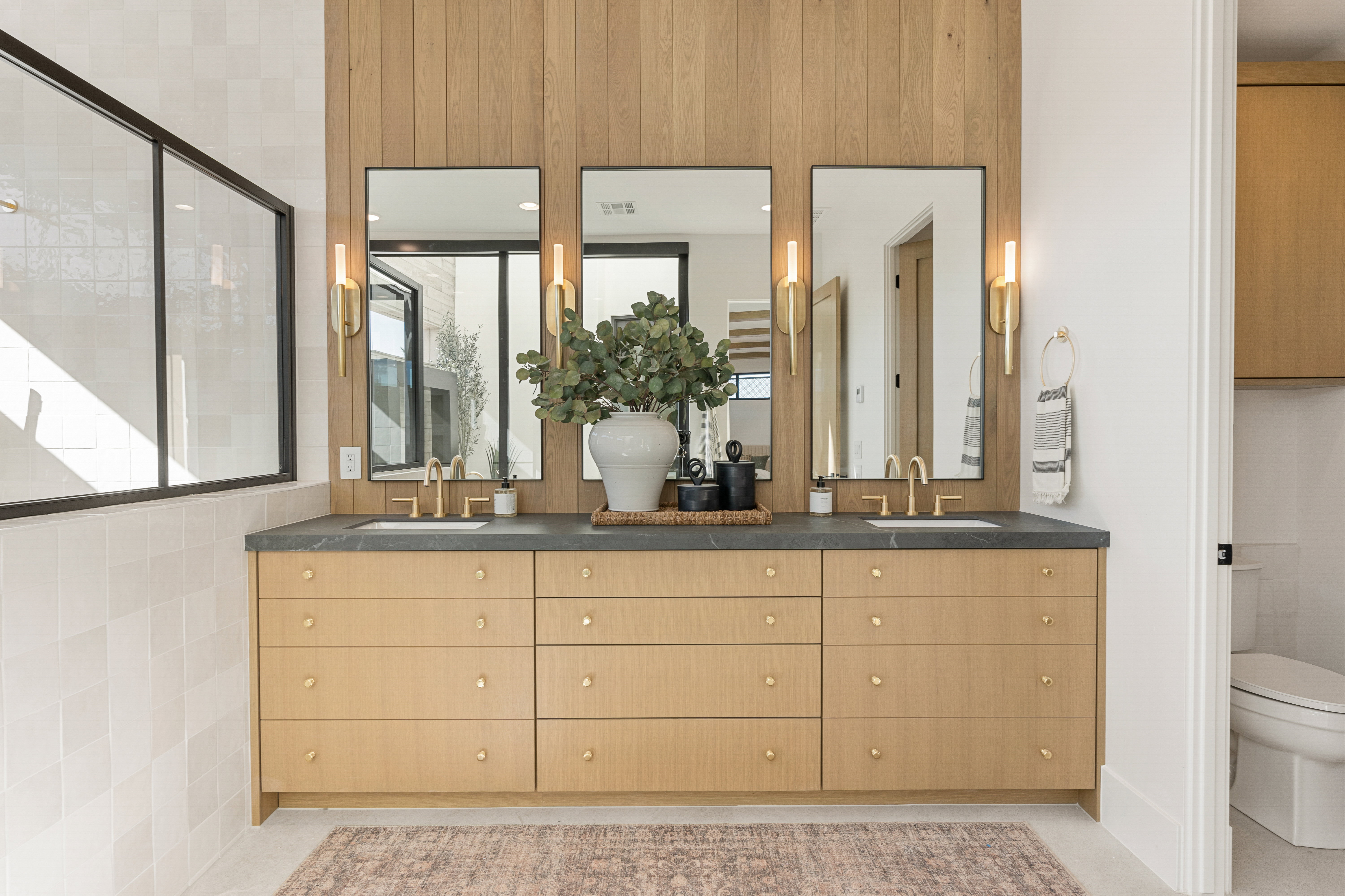 Bathroom featuring a stall shower and double vanity